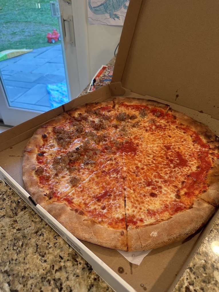 A family style Italian table with pasta and pizza
